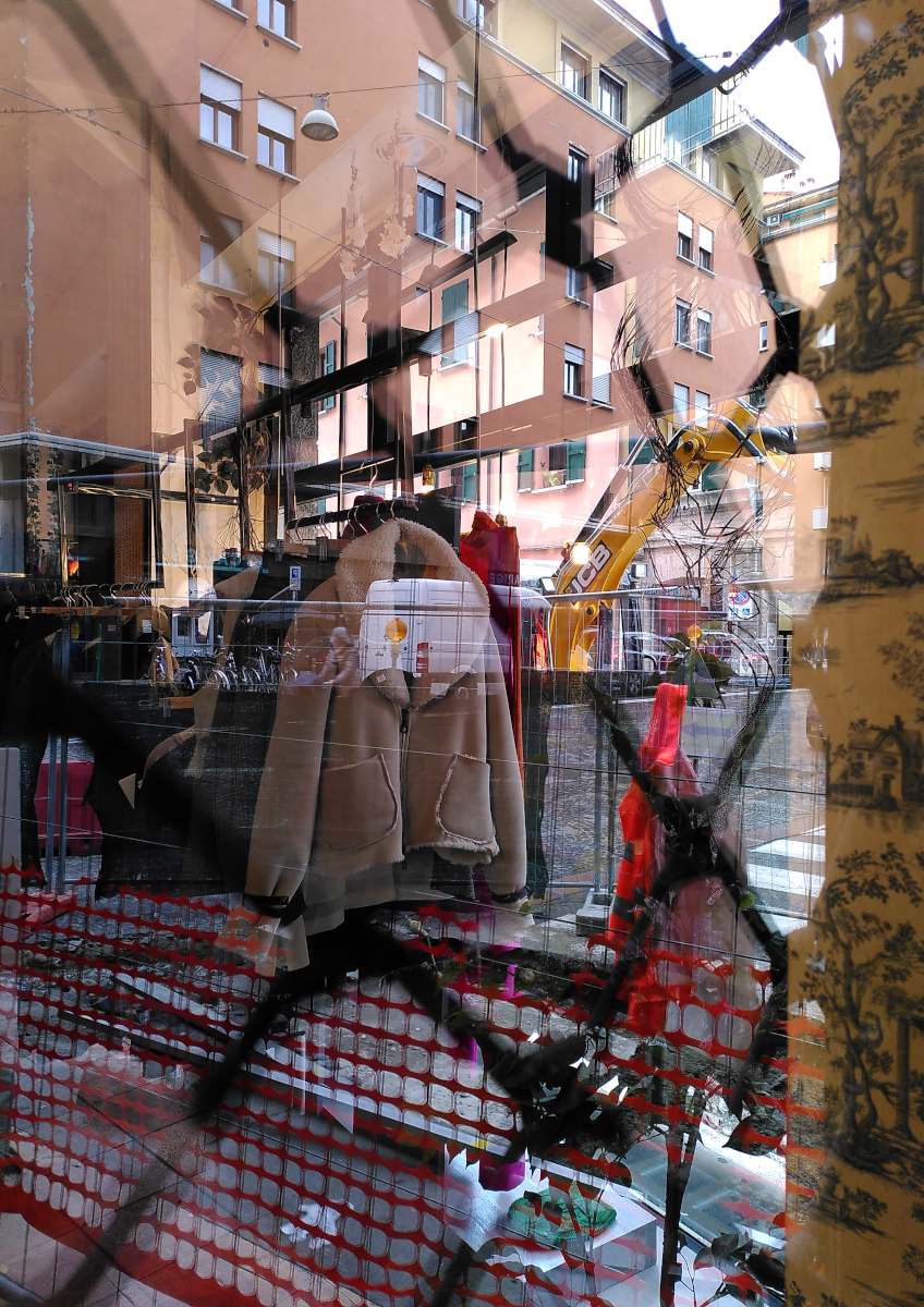 reflections of the surrounding streetlife in a boutique window